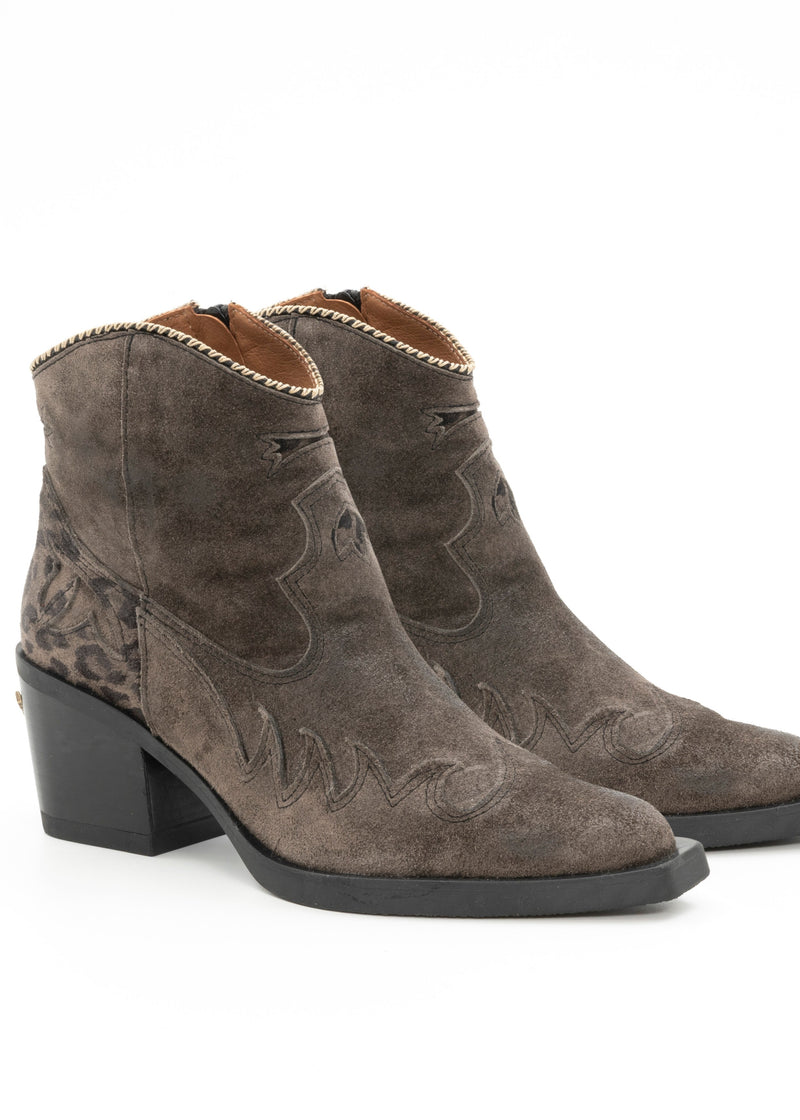 Pair of brown suede ankle boots on a white background